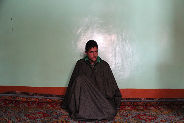 Muhammad Irfan Malik listens to his brother and mother talk about the disappearance and death of his father, Muhammad Yusuf Malik.