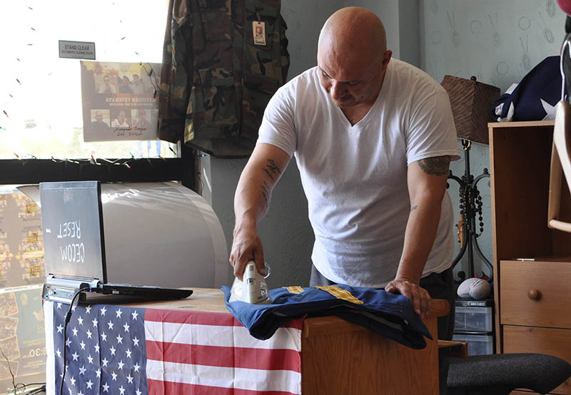 Hector Barajas ironing his dress blues at the TJ support house. He dresses in uniform to protest at the border on behalf of deported vets.