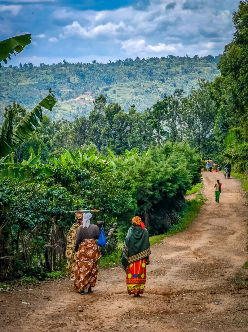 Two women walking on a dirt road in Kayanza, Burundi.