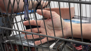 Josh Kline's installation about the expendability of workers features cast body parts in a shopping cart.