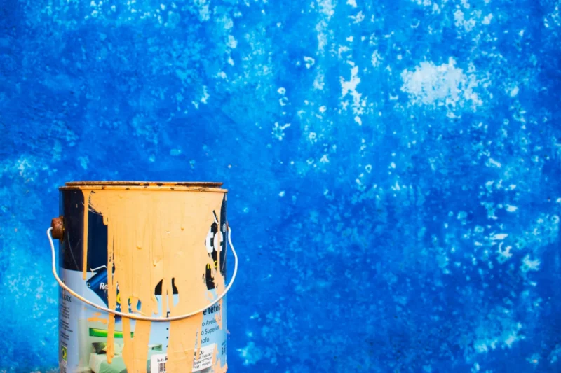 paint can by blue wall