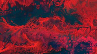 An abstract, inky, red red and blue painting of a vein