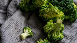 Fresh-cut broccoli on a gray tea towel